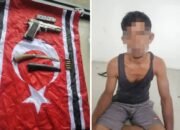 TNI mengamankan seorang demonstran yg kedapatan membawa senjata api dan mengibarkan bendera simbol Gerakan Aceh Merdeka (GAM) di Lhokseumawe, Aceh.